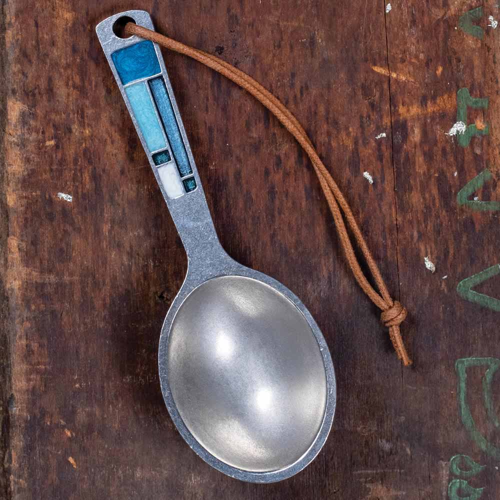 Blue-handled coffee scoop on cord