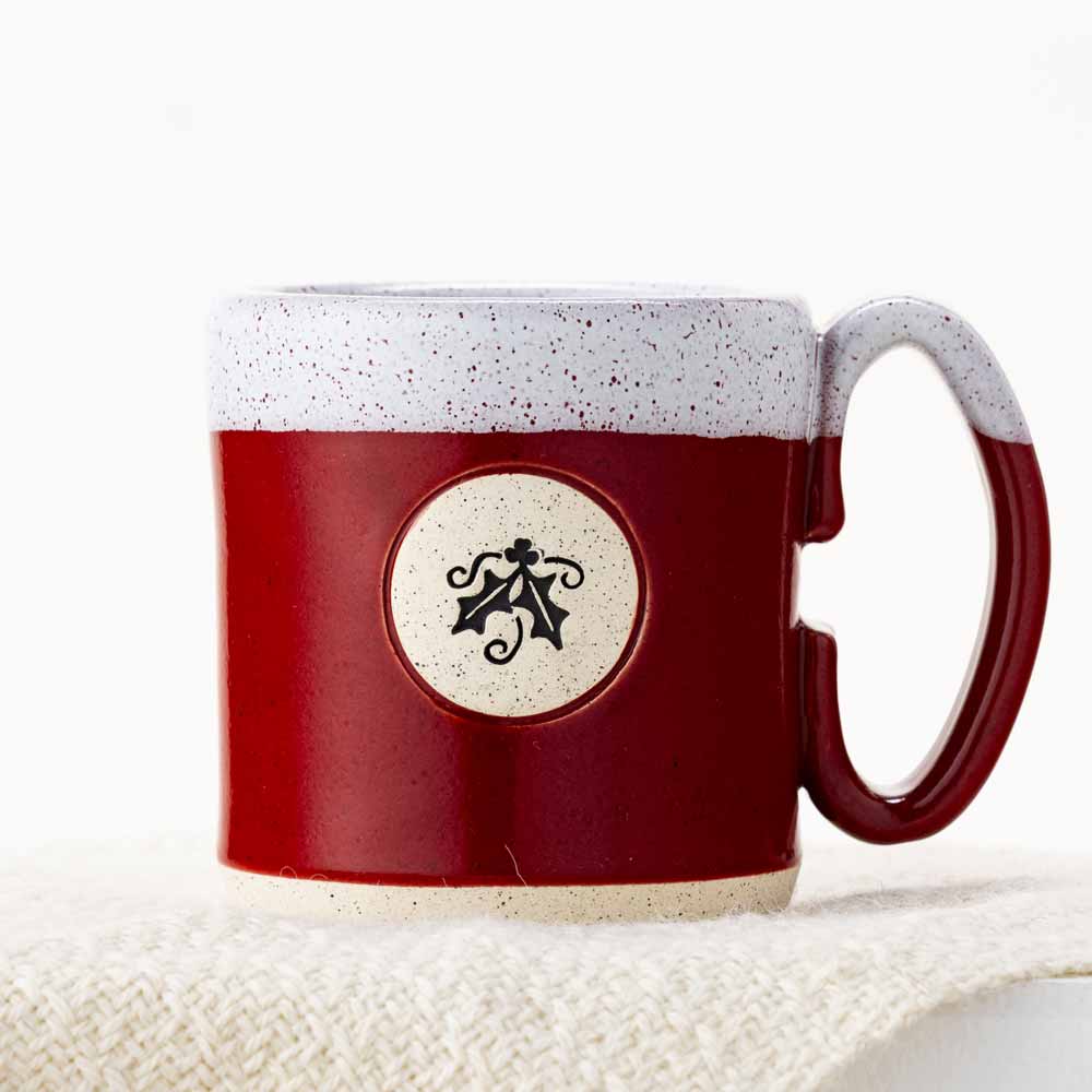 Red stoneware mug with holly design