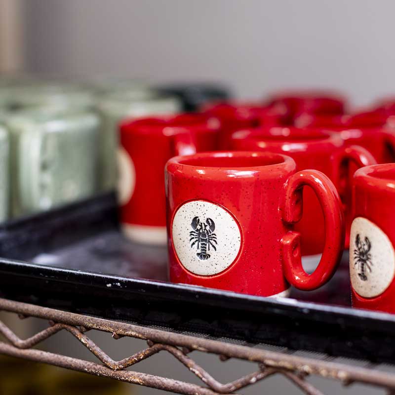 bright red coffee mugs with a lobster